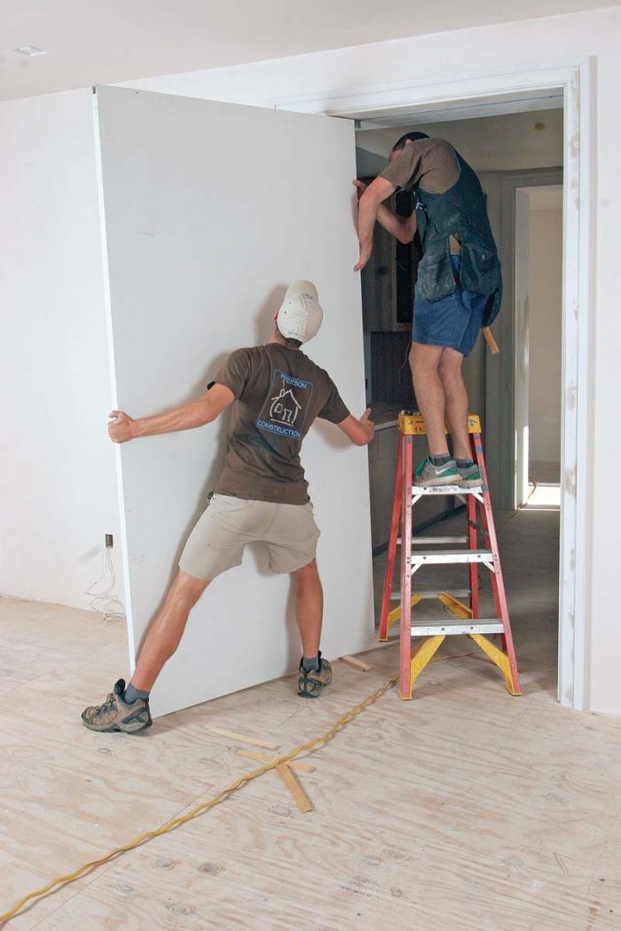 Hang time. Slide the pocket-side hanging hardware, which rotates for easier installation, into the aluminum U-channel on the top of the door before tightening the locking bolt