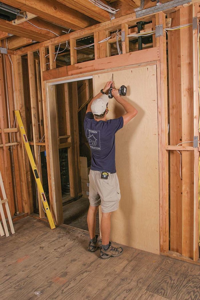 Close the pocket. With the track in place, fasten the second side of the pocket to the subfloor and surrounding framing with pocket screws.