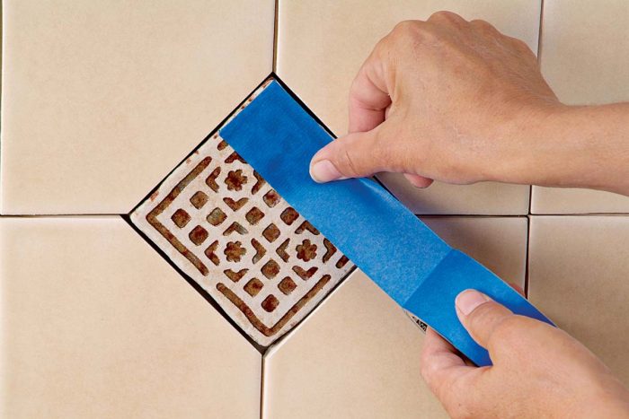 Painter’s tape masks deep ridges in deco tile when grouting.