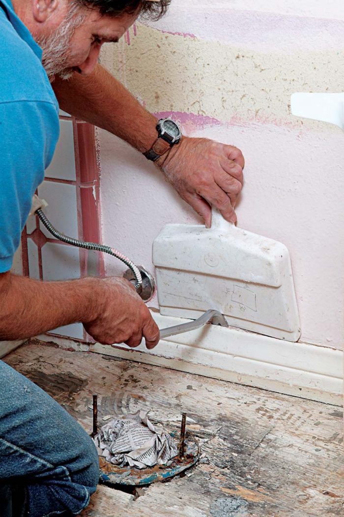 A dustpan protects walls when you pry off the baseboard.