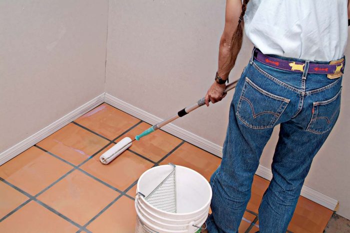 Roll the sealer onto the floor, making sure tile faces and grout joints are fully covered.