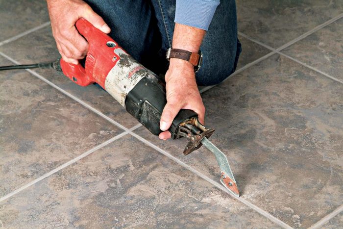 硬质合金浆液刀片连接到你的reciprocating saw quickly removes grout from around tiles.