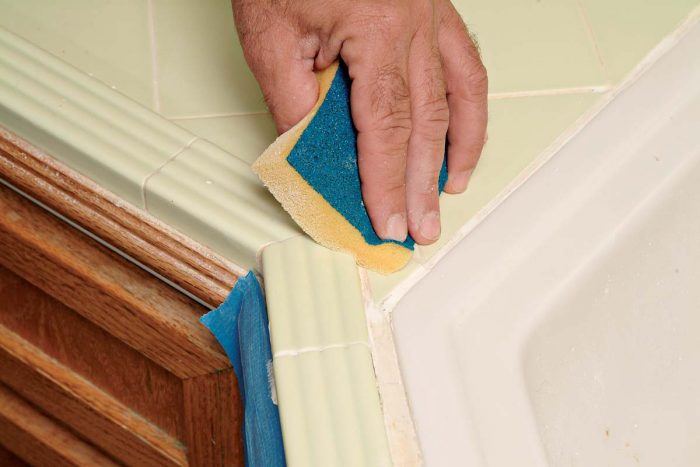 Wipe the grout with a sponge, blending the new grout with the old.