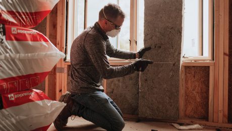 Installing mineral wool insulation in a wall assembly